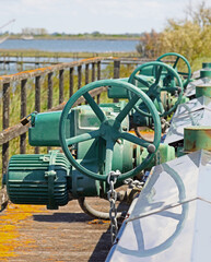 Industrial motorized sluice gates to regulate water flow in marshy areas and operate pumping stations