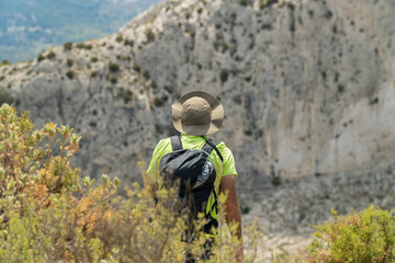 Obraz premium Male hiker walking on mountains on a summer day.