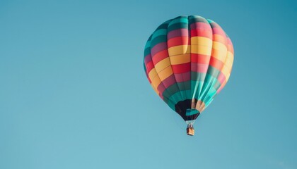 Fototapeta premium Colorful Dreams: A Hot Air Balloon's Journey in the Clear Blue Sky