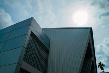 A large building with a lot of windows and a metal roof