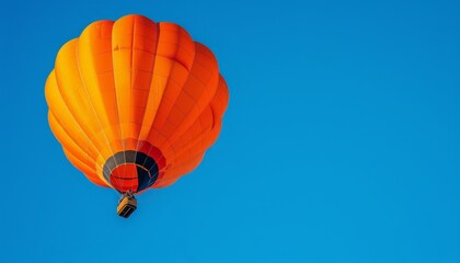 Fototapeta premium Vibrant Orange Hot Air Balloon Soars Through the Blue Skies of Amersfoort, The Netherlands