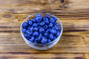 Blueberry in glass bowl on a wooden table