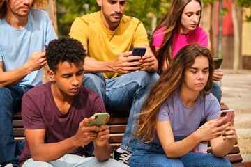 Group of friends watching smart mobile phones, teenagers addiction to new technology trends.
