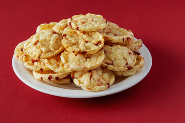 Potato chips with red beets on a red background