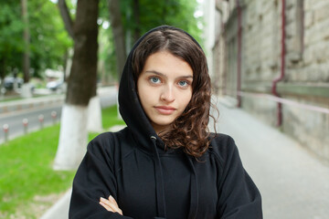 White teenager with curly hair and the most beautiful natural lips. Young girl face.