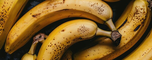 ripe bananas artfully arranged on a vibrant yellow background.