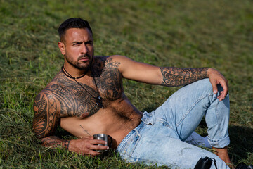 Sexy Man in grass farm on countryside. Sexy Farmer with bare naked torso. Muscular sexy farm worker...