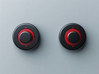 Pair of black and red buttons on gray surface