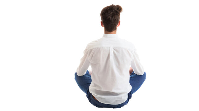 Back view of a young man sitting cross-legged, wearing a white shirt and blue pants. The background is isolated, emphasizing the relaxed and contemplative pose.