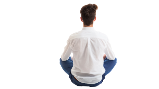 Back view of a young man sitting cross-legged, wearing a white shirt and blue pants. The background is isolated, emphasizing the relaxed and contemplative pose.