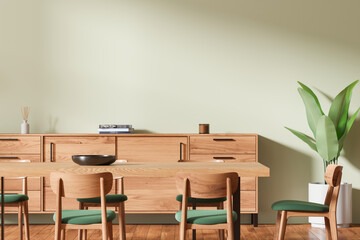 Green home living room interior with wooden table and chairs, sideboard