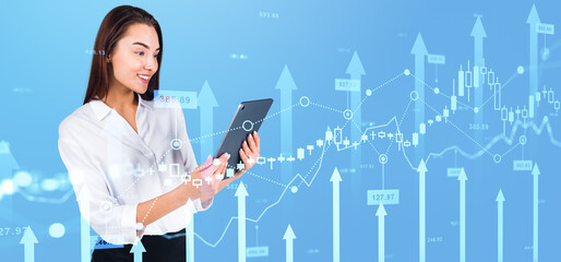 Businesswoman using tablet, forex diagrams with arrows and candlesticks