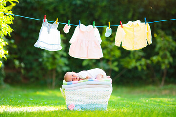 Baby boy on a pile of towels outdoors