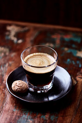 Coffee in glass cup on dark background. Close up. Copy space