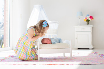 Kids play with newborn baby brother