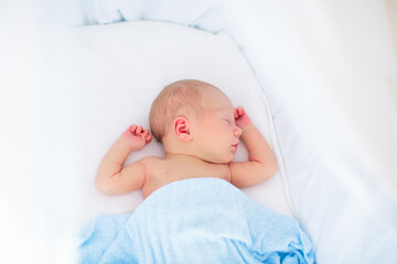 Little baby on white bed