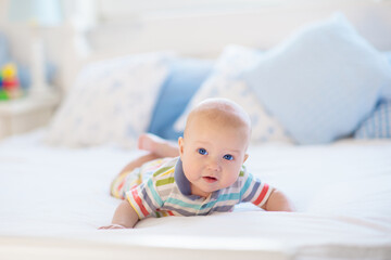 Little baby on white bed