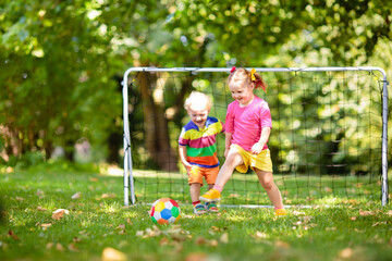 Kids play football. Child at soccer field.