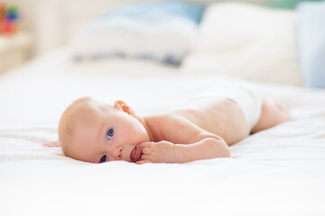 Little baby on white bed