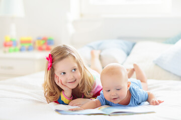 Little girl playing with baby boy