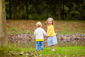 Kids play in summer park. Children run outdoor