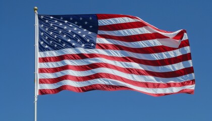 Obraz premium Flag of United States of America being waved in the breeze against a sky. USA flag