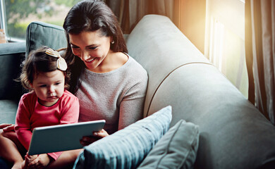 Education, mother and child with tablet on sofa together for internet connection and development in...