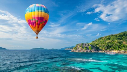 Fototapeta premium Sky High: Vibrant Hot Air Balloon Soaring over the Azure Sea at 7:4