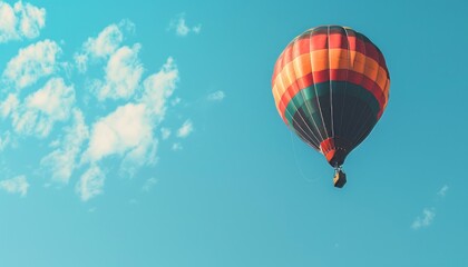 Naklejka premium Vibrant Journey: A Colorful Hot Air Balloon Soars Through the Blue Sky - AR 7:4