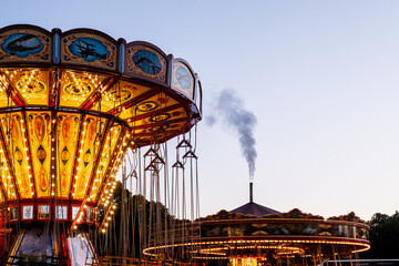 an amusement rides for passengers on a cloudy night sky background