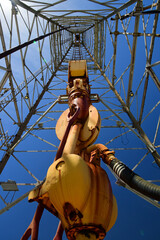 looking up at at an offshore oil and gas drilling rig in galveston harbor, texas, on a sunny spring...