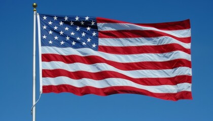 Obraz premium Flag of United States of America being waved in the breeze against a sky. USA flag