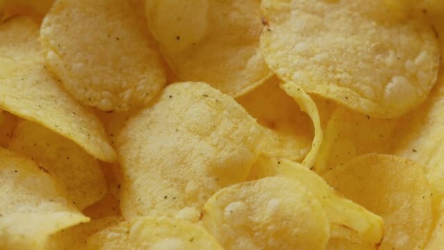Fast food snacks. Potato chips rotating close up. Potato snack for unhealthy fast food
