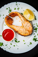 grilled salmon with sauce and lemon