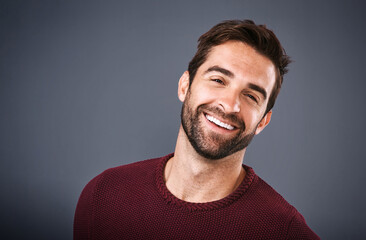 Obraz premium Studio, face and sweater for man, fashion and confidence in mockup space, pride and cardigan in winter. Gray background, portrait and person in Miami, happy or comfortable in clothes, joy or jersey