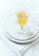 Glass of beer on bright wooden background. Copy space.
