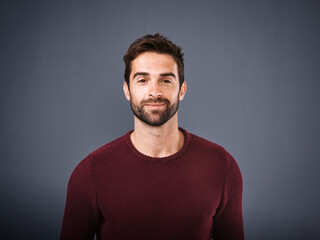 Studio, smile and confidence of man, portrait and mockup space for fashion, trendy and calm in winter. Grey background, face and thinking of person, pride and happiness in organic cotton of jersey