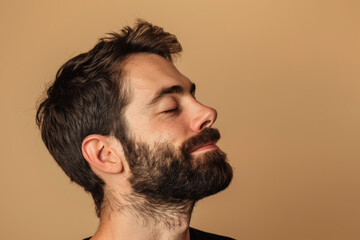 Obraz premium A close up of a man with beard and closed eyes looking to a side