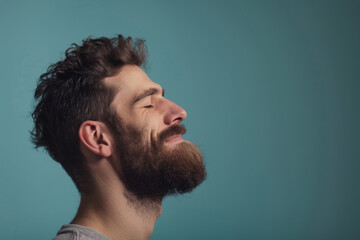 Fototapeta premium A close up of a man with beard and closed eyes looking to a side