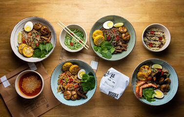 Asian cuisine. Noodles with egg and corn in a plate. On a dark background