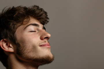 Fototapeta premium A close up of a man with beard and closed eyes looking to a side