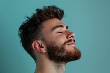 Obraz premium A close up of a man with beard and closed eyes looking to a side