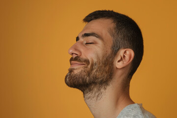 Fototapeta premium A close up of a man with beard and closed eyes looking to a side