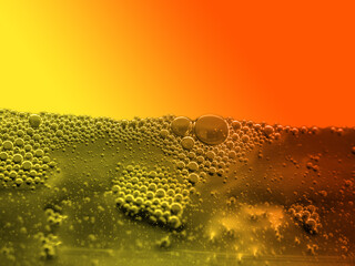 orange juice and water bubbles on orange background with copy space