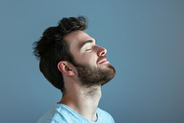Obraz premium A close up of a man with beard and closed eyes looking to a side