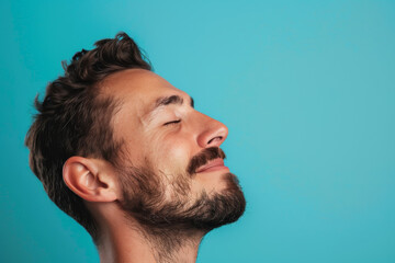 Fototapeta premium A close up of a man with beard and closed eyes looking to a side