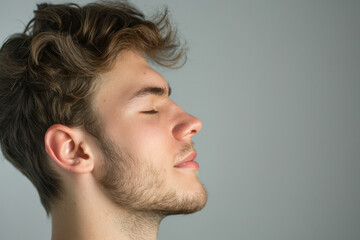 Fototapeta premium A close up of a man with beard and closed eyes looking to a side