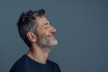 Fototapeta premium A close up of a man with beard and closed eyes looking to a side