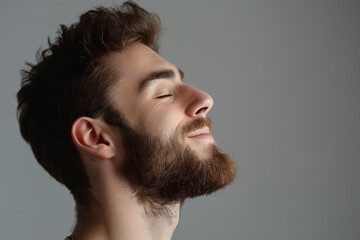 Fototapeta premium A close up of a man with beard and closed eyes looking to a side