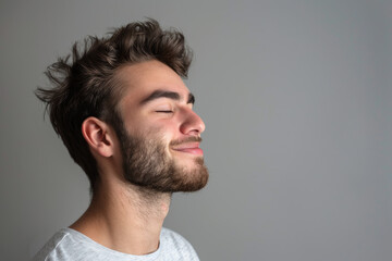Obraz premium A close up of a man with beard and closed eyes looking to a side